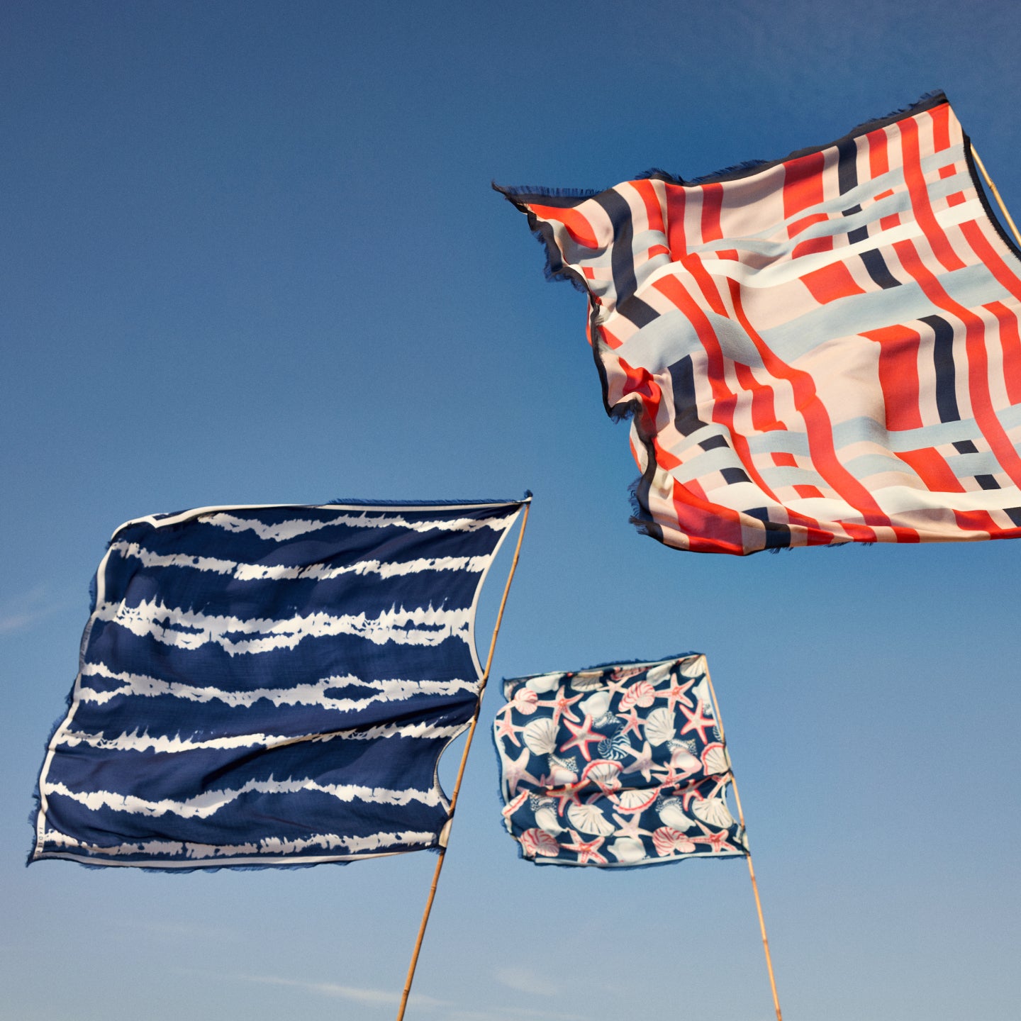 Colourful flags against a bright blue sky