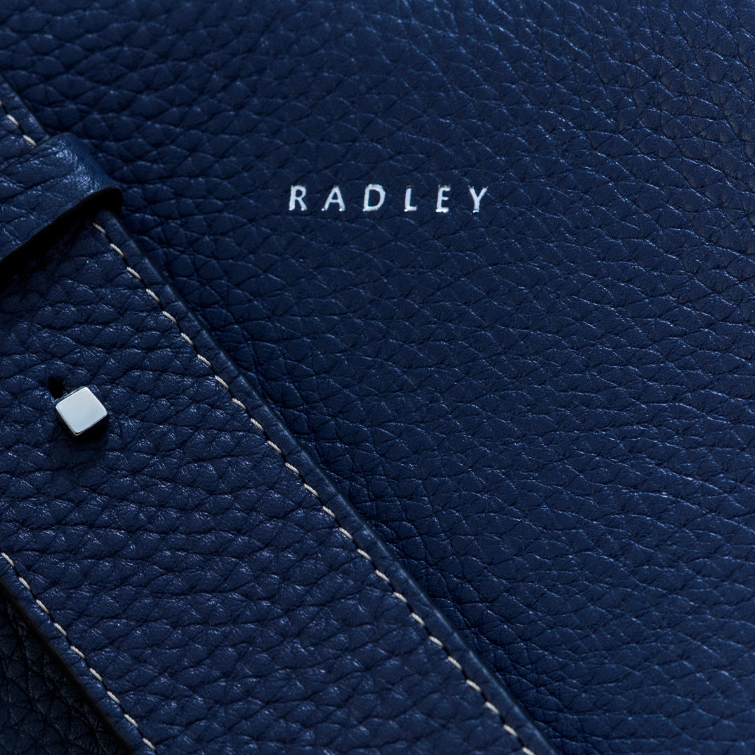 Close-up of a blue leather product with 'RADLEY' branding.