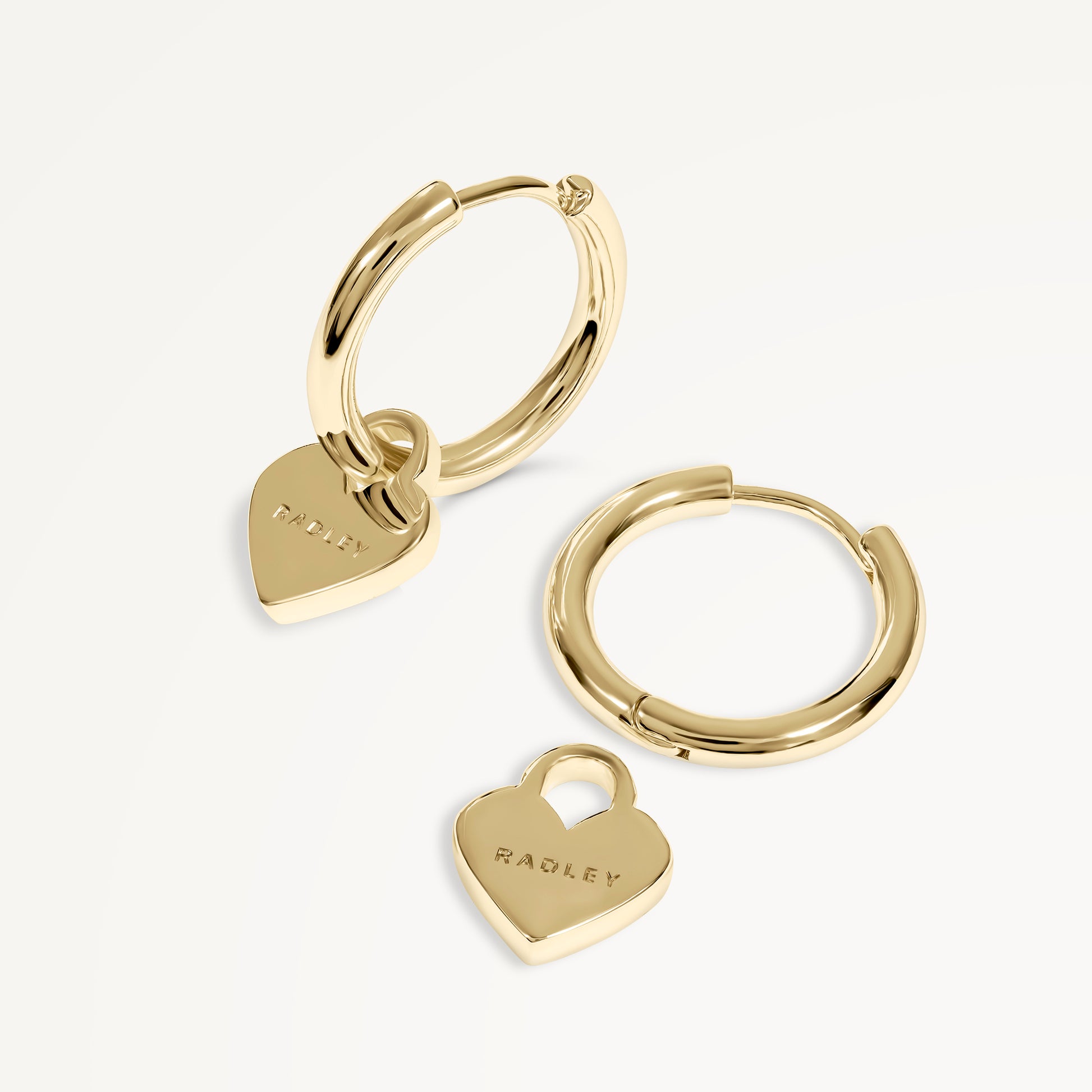 SELSEY STREET HANGING HEART HUGGIE EARRINGS GOLD
