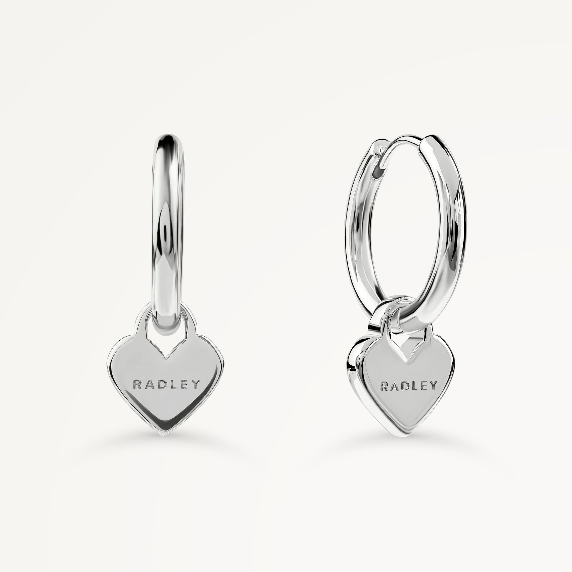 SELSEY STREET HANGING HEART HUGGIE EARRINGS SILVER