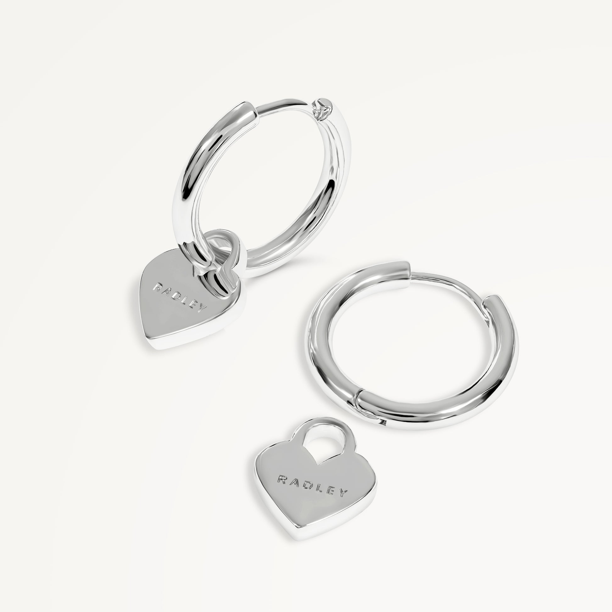 SELSEY STREET HANGING HEART HUGGIE EARRINGS SILVER